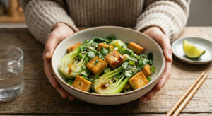 Bowl of crispy oven-baked tofu and bok choy salad tossed in spicy peanut dressing